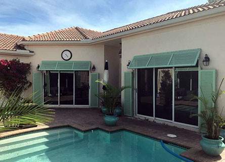 Seafoam Bahama hurricane shutters on a Florida pool home