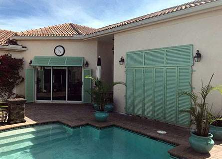 Bahama shutters closed for storm protection over patio doors