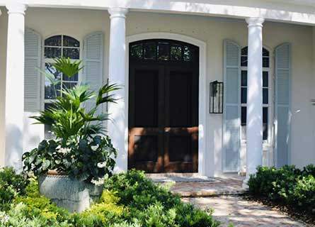 Colonial style hurricane shutters on a home